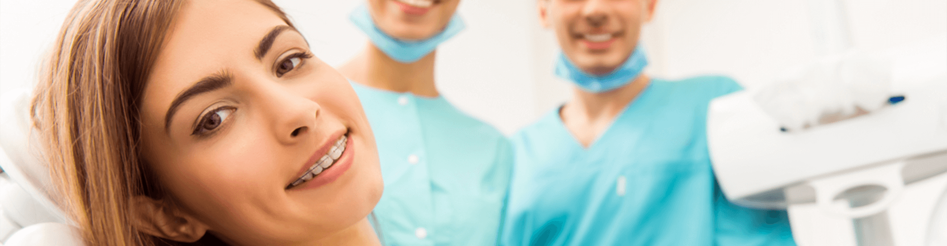 Girl with braces smiling in the dentist chair