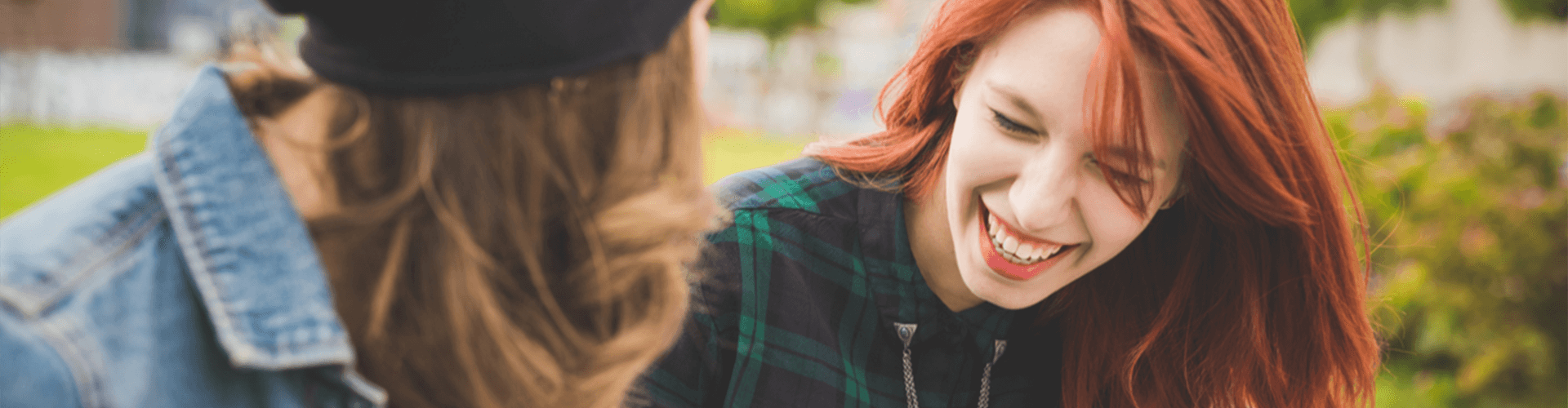 two girls laughing and smiling