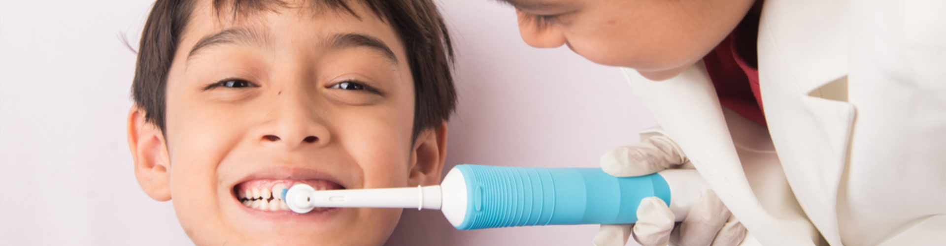 One child brushing another child's teeth