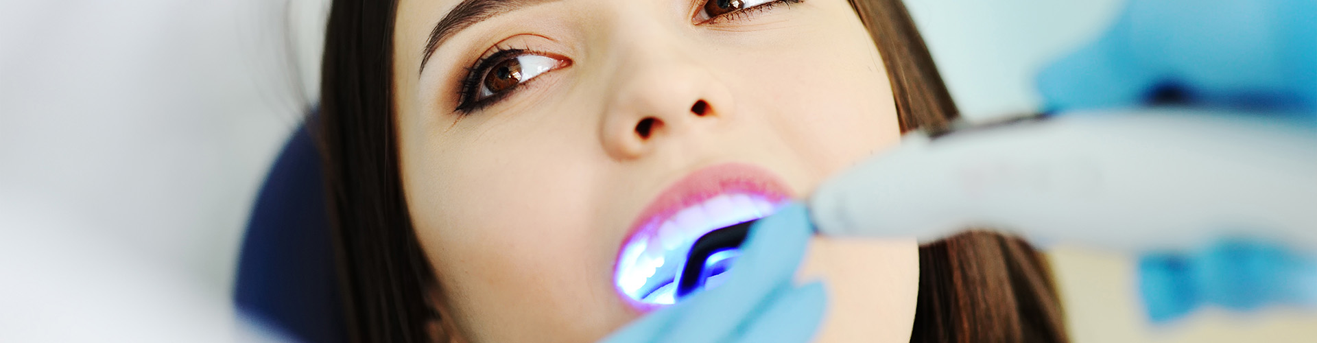 led light shining into woman's mouth