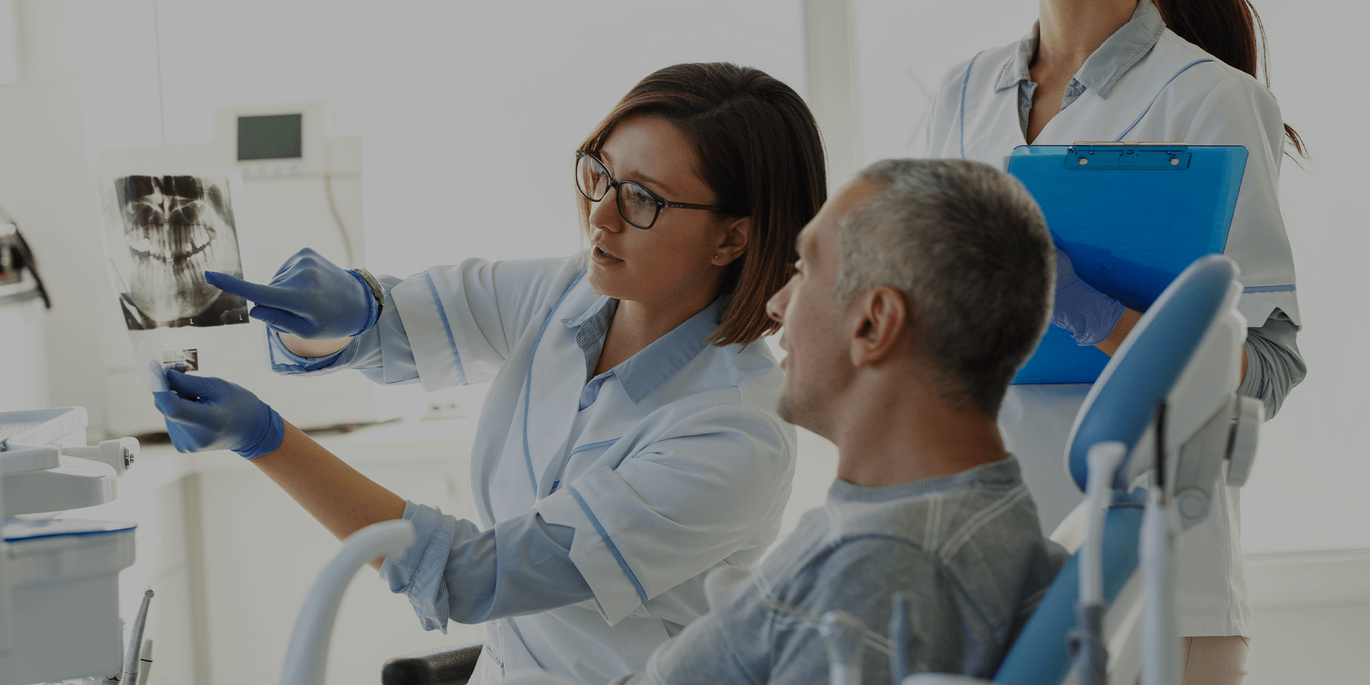 A dentist showing dental X-rays to a patient.
