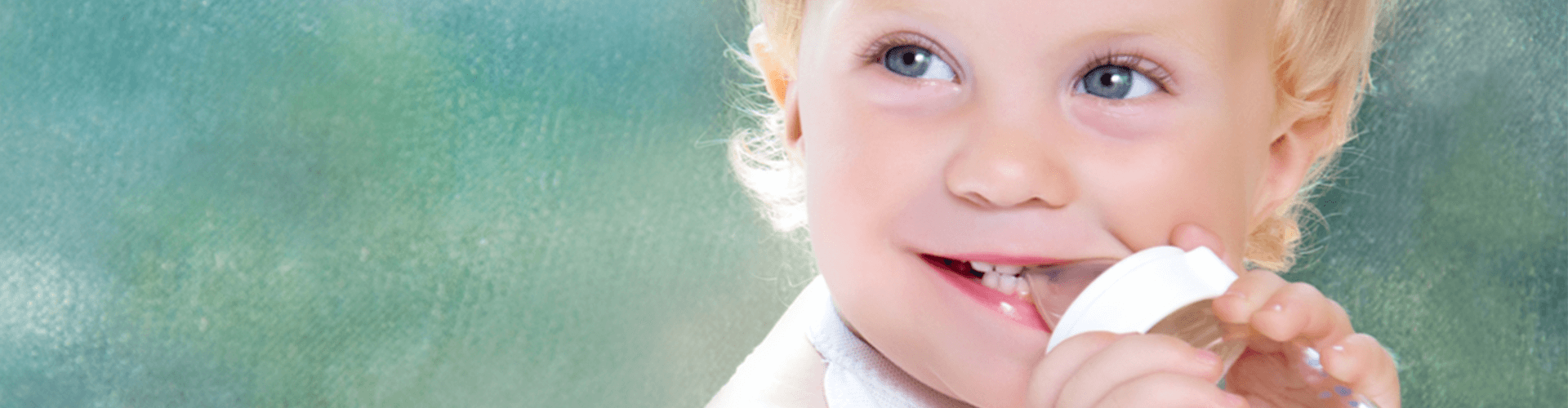 baby chewing on sippy cup 