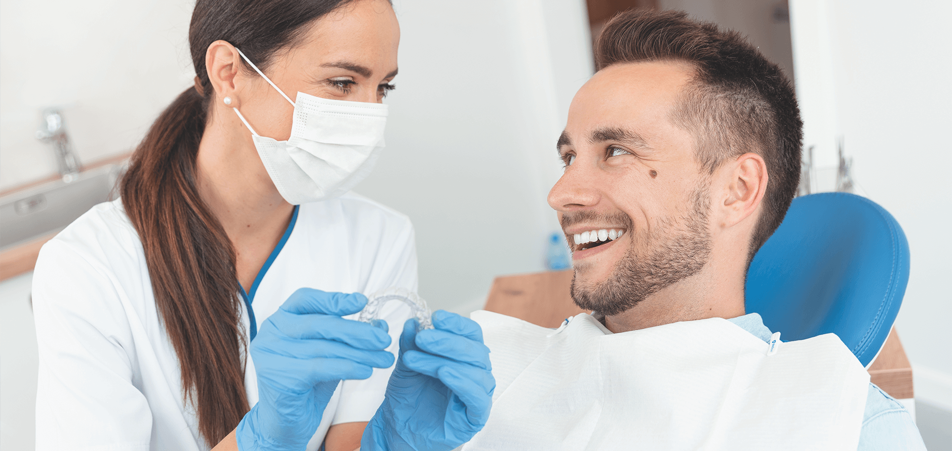 Patient trying on her visalign appliance