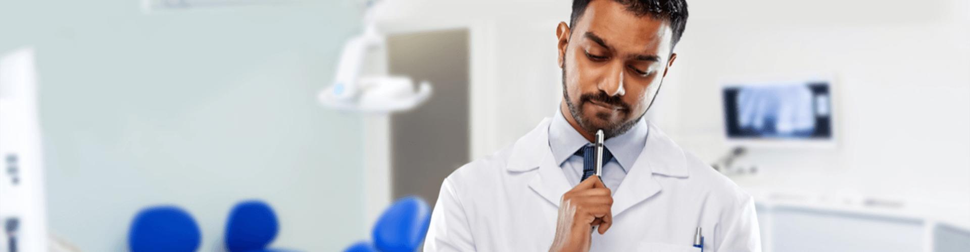 dentist holding a clip board 