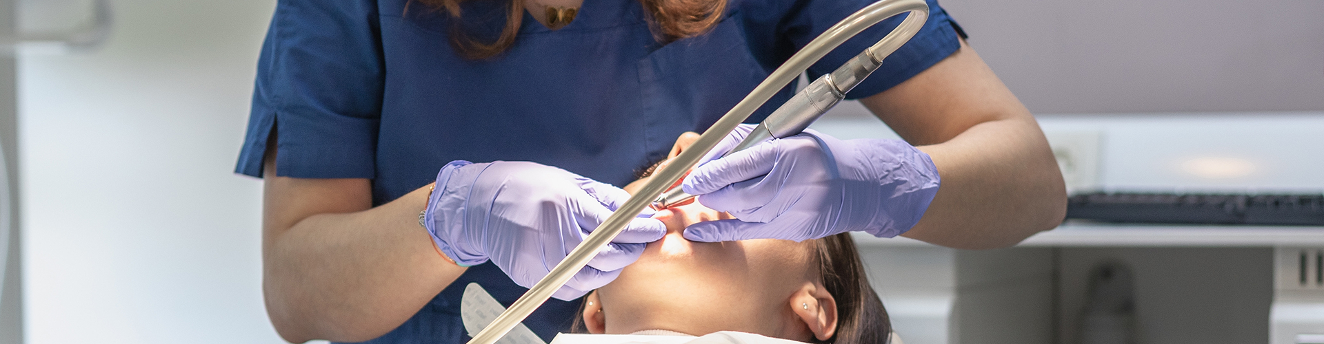 dentist using dental tools in patient's mouth
