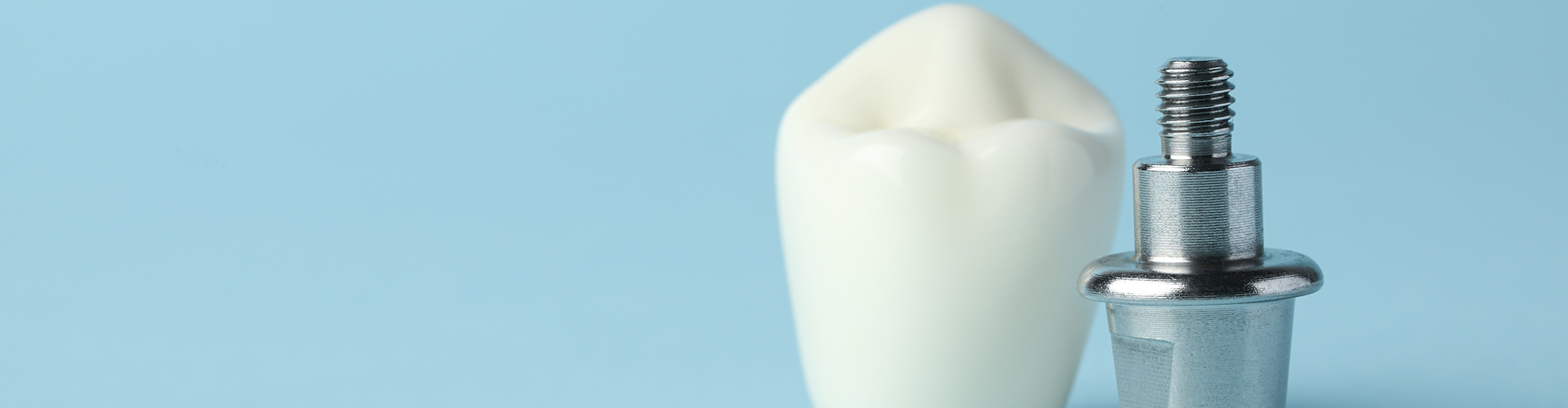 dental crown beside a metal implant