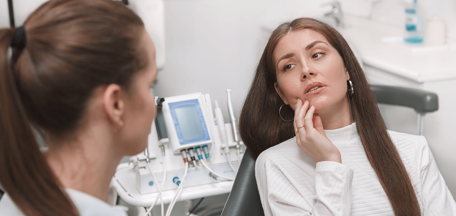 Dentist looking at a patient with toothache.