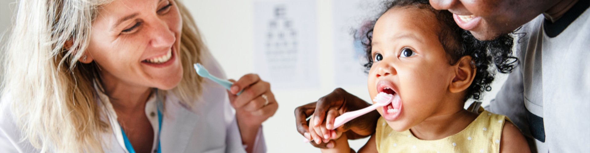 toddler and dentist brushing their teeth 