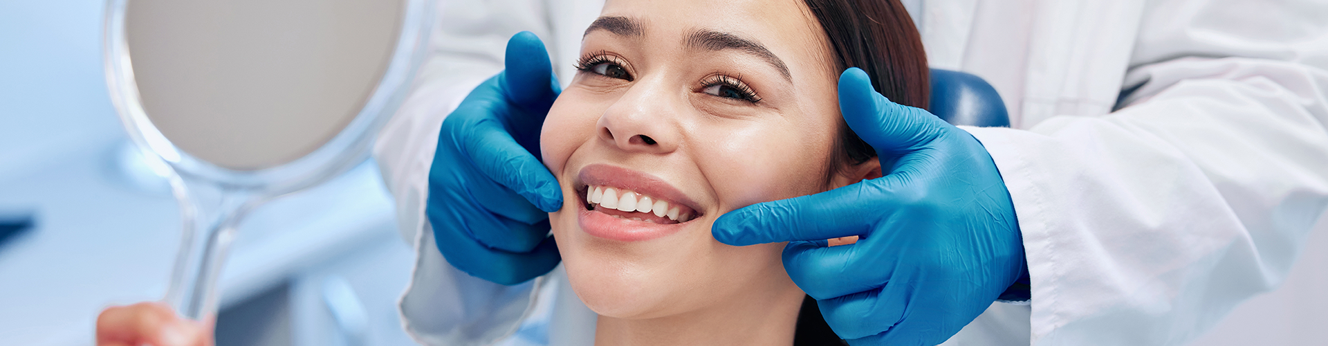 gloved hands framing woman's smile