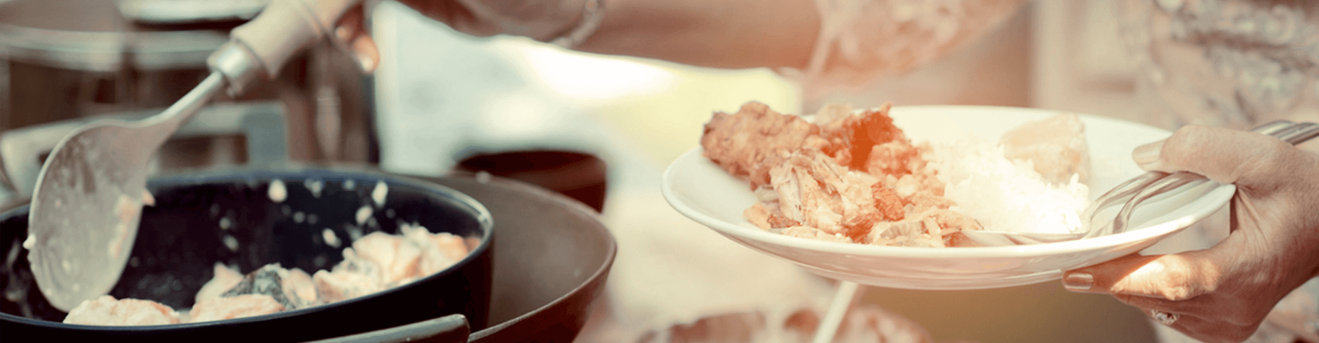Woman putting food on her plate