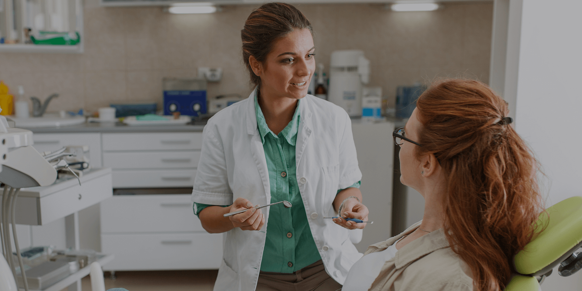 A dentist explaining treatment to a patient.