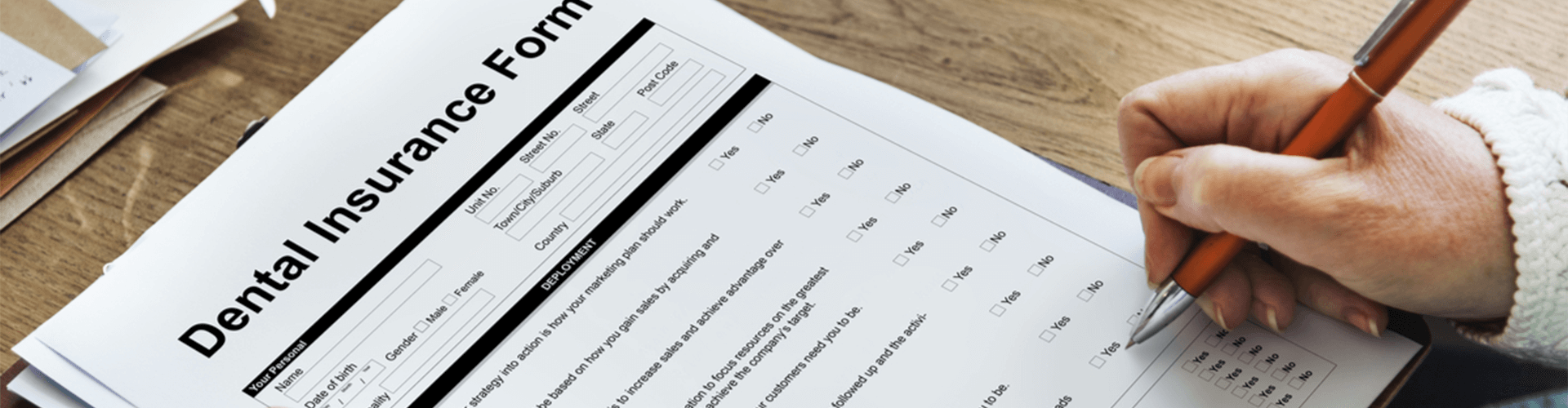 woman filling out insurance papers