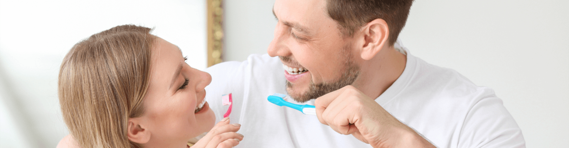 couple brushing their teeth together