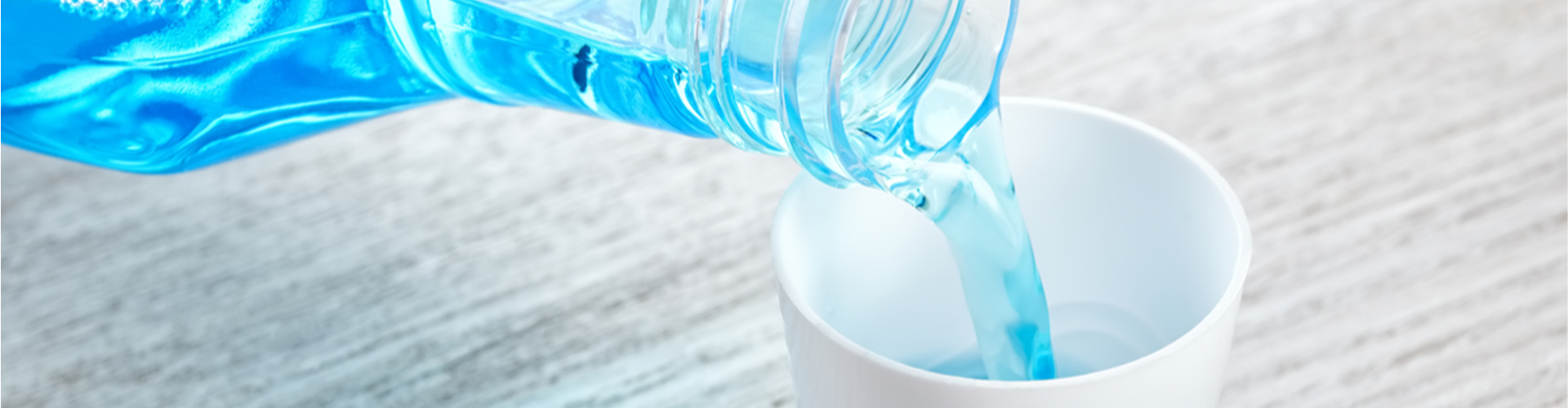 Mouthwash pouring into a cup