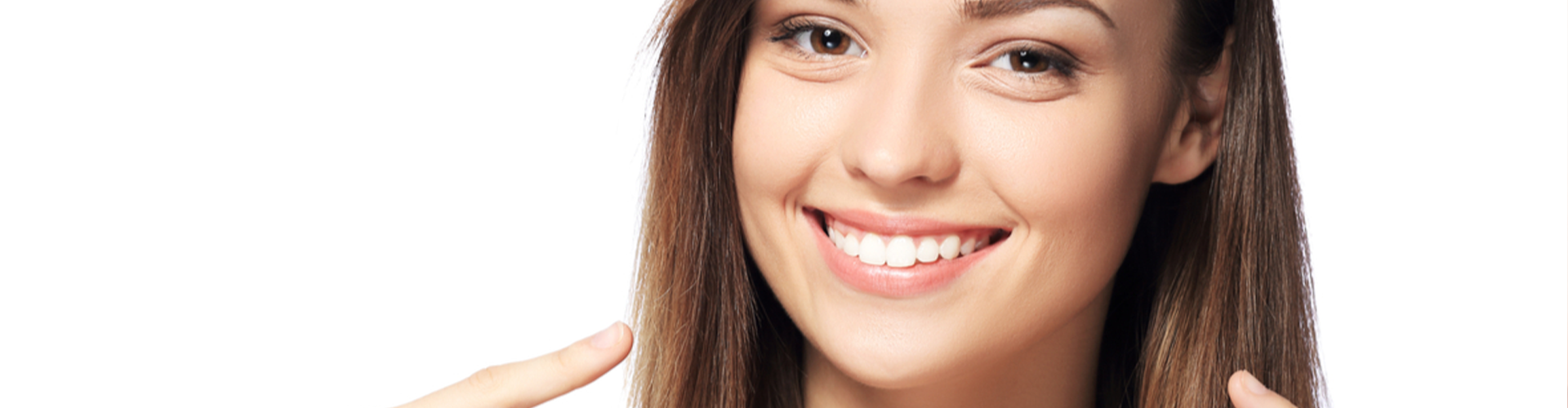 Girl smiling and pointing to her teeth