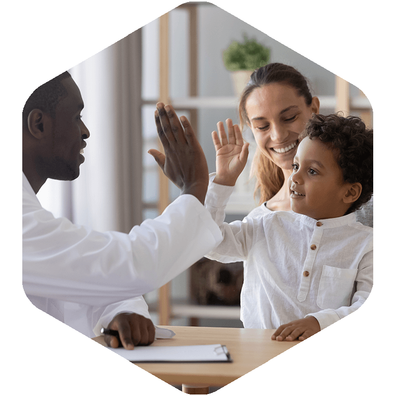 Dentist giving a high five to a child patient.