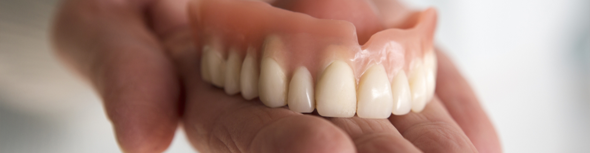 Dentures in a hand