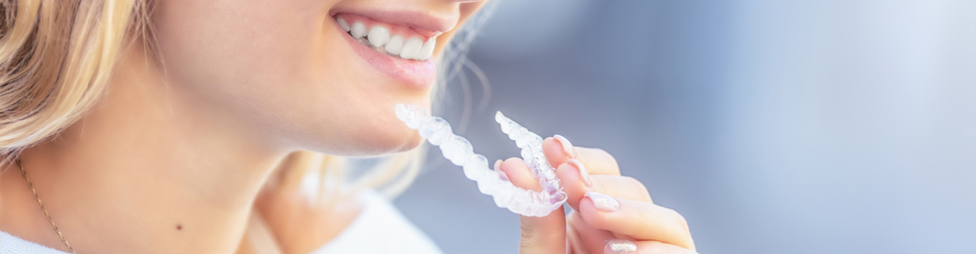 woman inserting clear aligners
