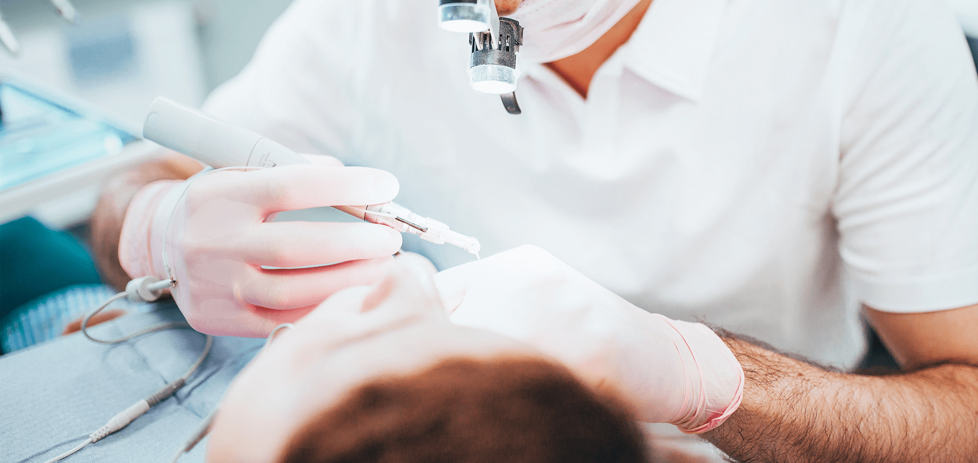 Dentist performing root canal surgery on patient.