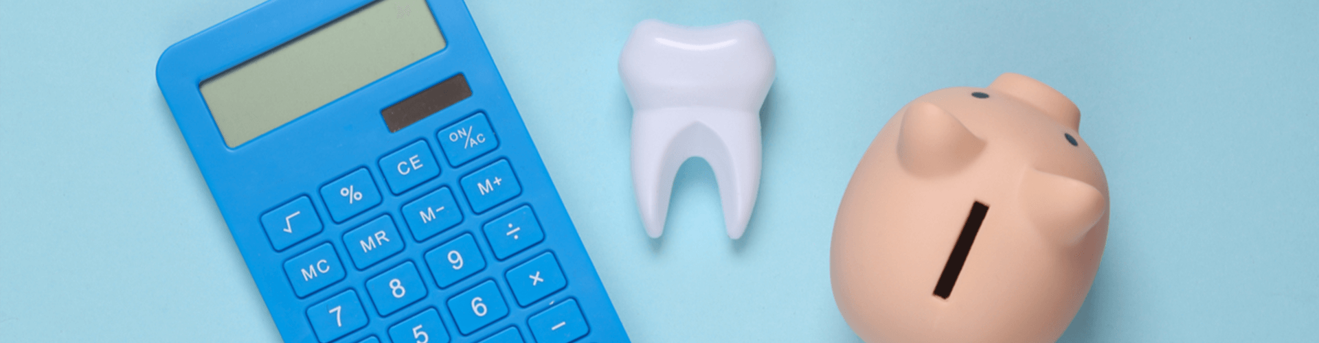 calculator, a tooth and a piggy bank 