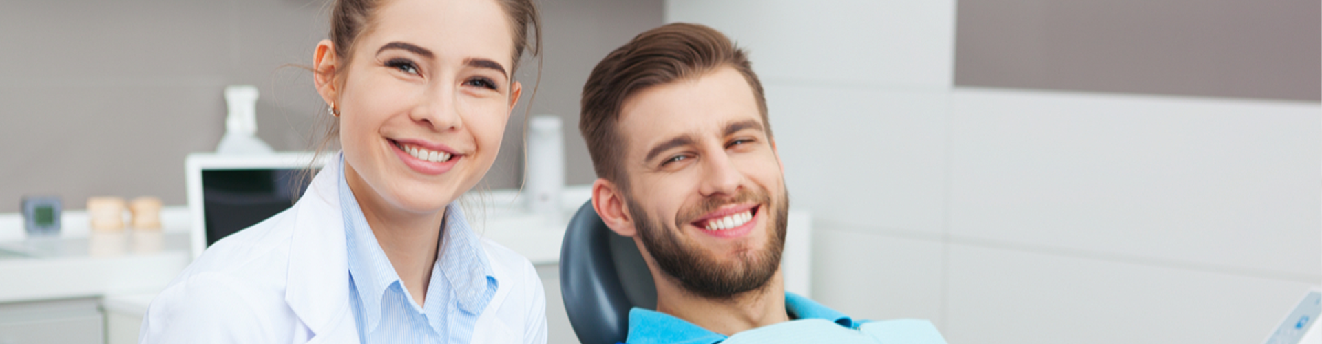 Patient and dentist smiling together